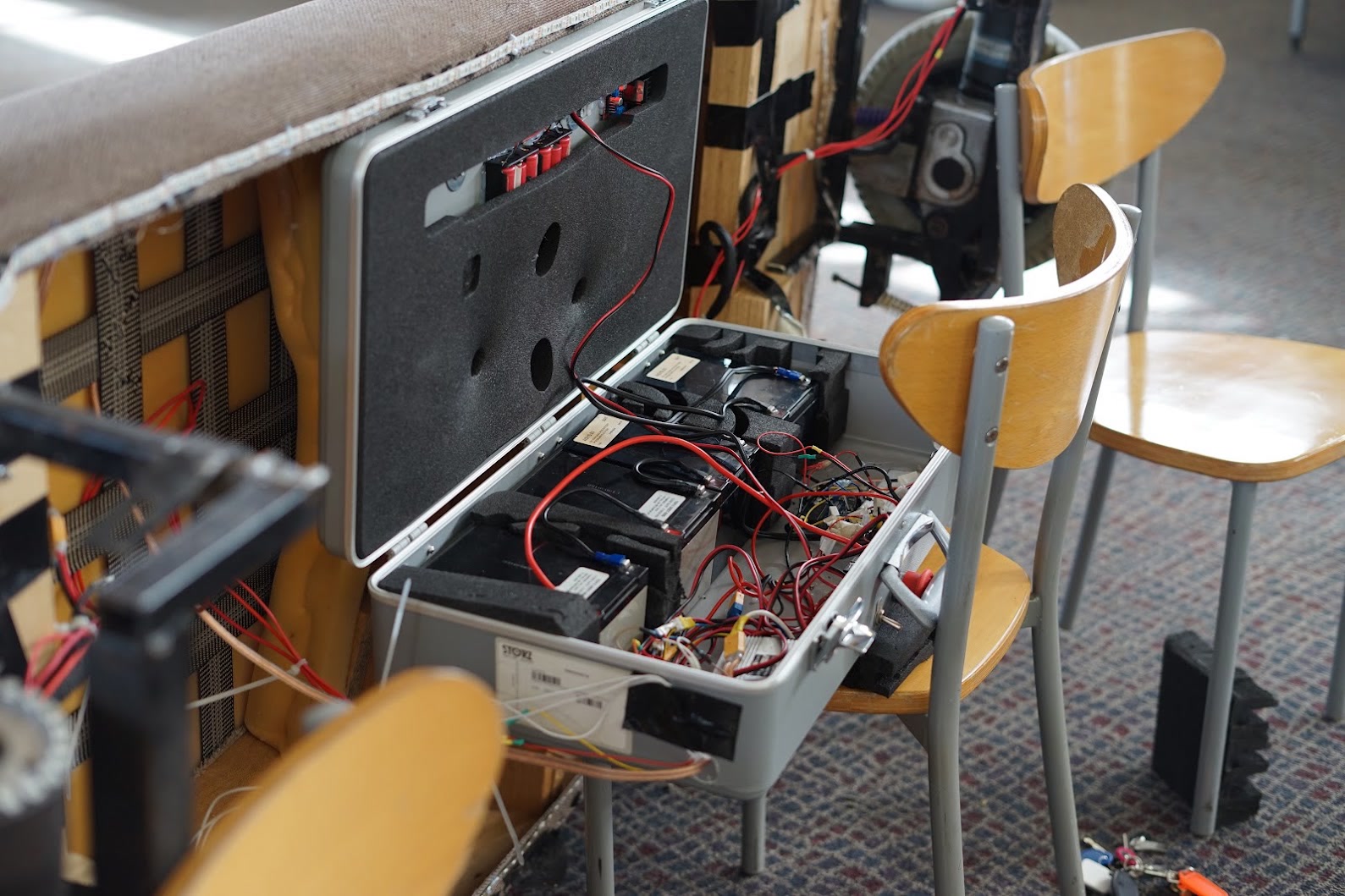 Terrible Ideas Hackathon: a flight case packed with batteries and red wiring, powering the team's build